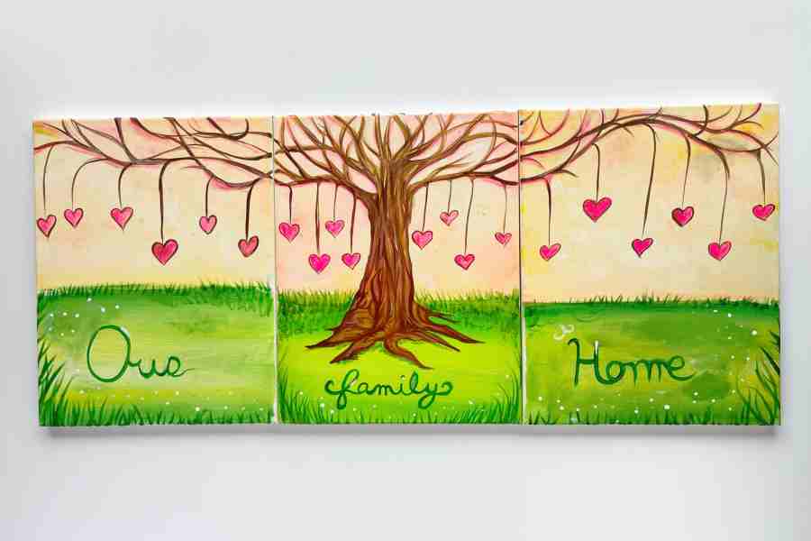 3 canvases featuring a tree with decorative hearts hanging from the branches, our family home is written in the grass beneath the tree.