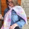 Participant painting colourful abstract silk scarf at Fresh Paint Studio Toronto