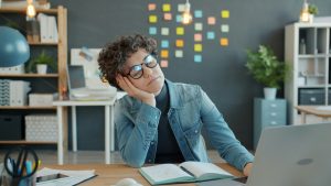 Employee experiencing workplace stress, showing why thoughtful appreciation gifts for employees can support wellness and creative breaks.